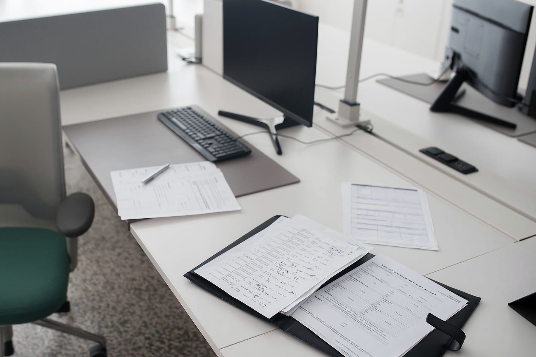 Business documents arranged beside workstations in a modern office